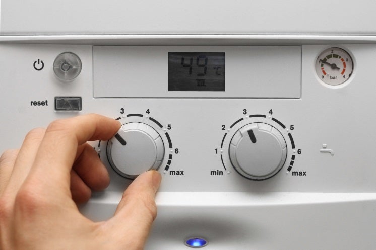 a person changes the settings on a vaillant boiler