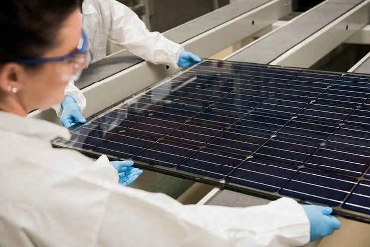 a Oxford PV perovskite-silicon solar module held by a female scientist