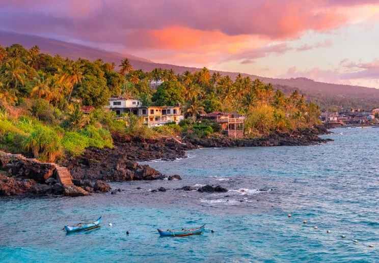 a landscape at sunset with the ocean, sky, and a mountain on Grand Comore island, in Comoros
