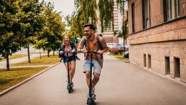 man and woman ride on electric scooters