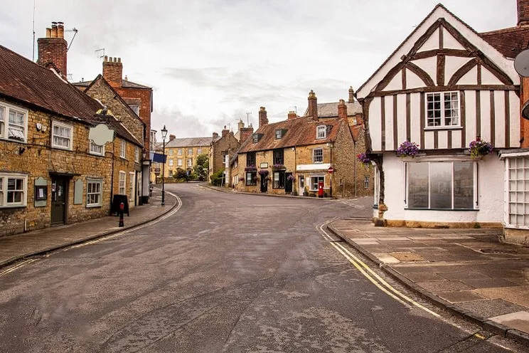 street view of traditional English stone and wood beam houses