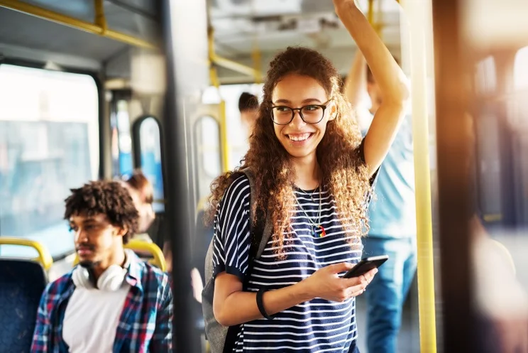 woman standing on a public transport vehicle