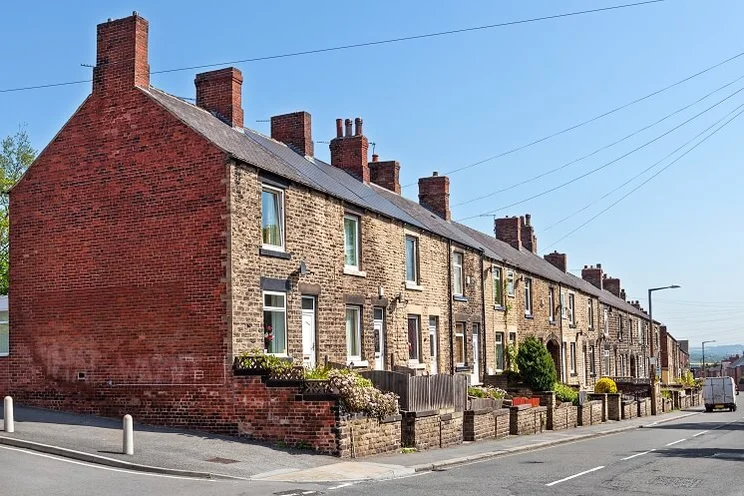 red brick terraced houses with small brick-walled front gardens