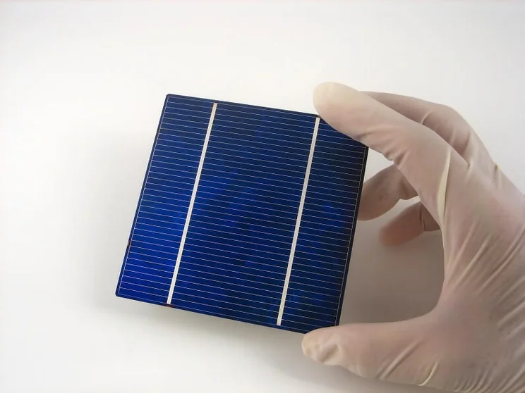 Person in latex gloves holding a solar cell