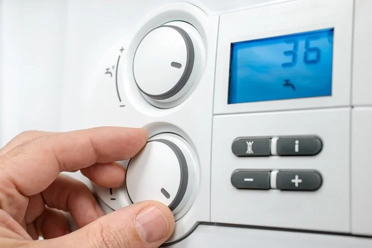 someone changing their boiler temperature