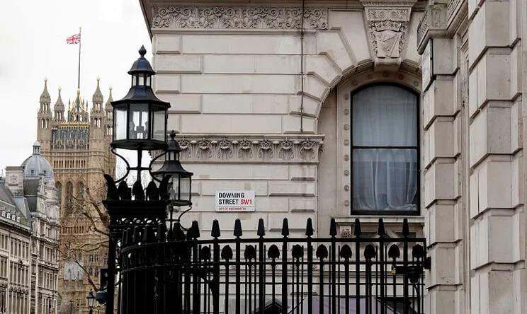 A view of the entrance to Downing Street in Westminster with the Houses of Parliament building in the background
