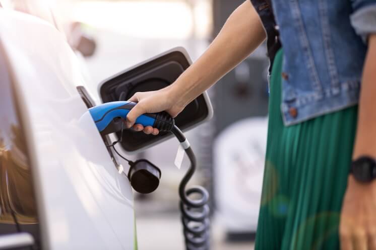 woman charging her electric vehicle