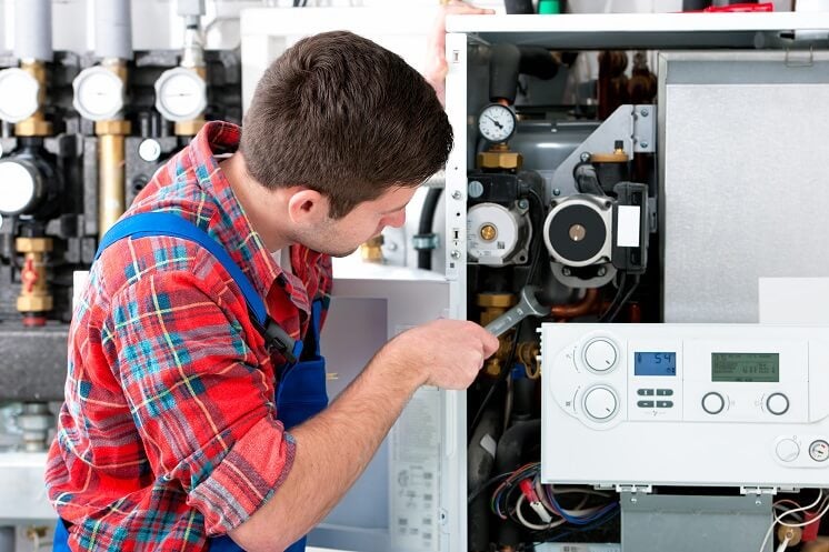 man fixing boiler