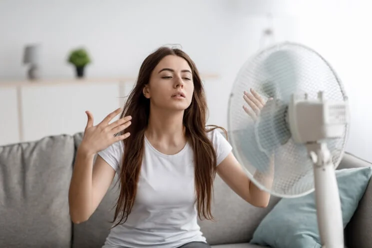 woman using an electric fan