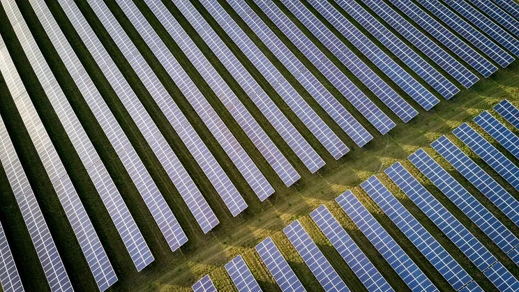 Aerial view of a solar panel farm in the countryside