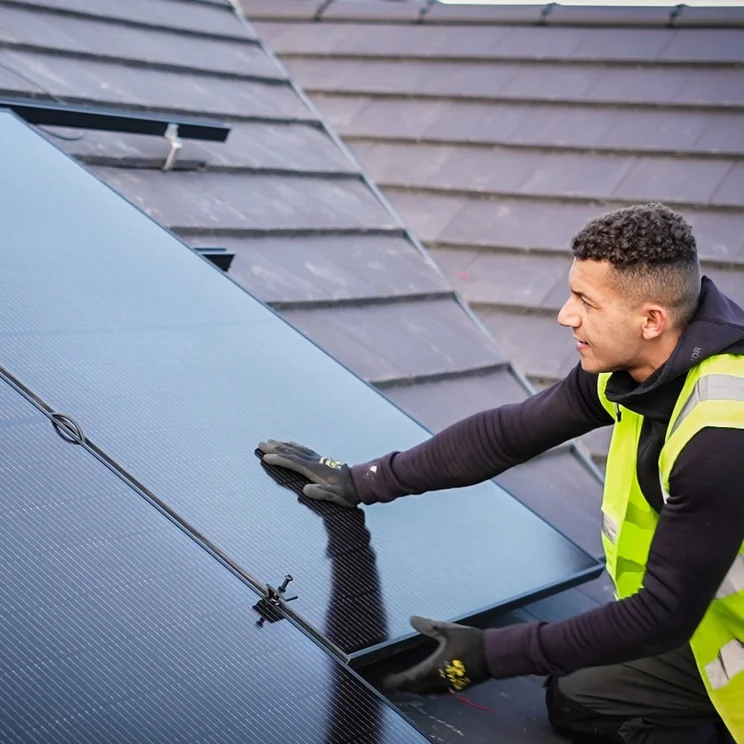large solar panels being installed on a roof