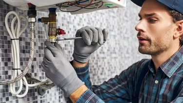 man fixes glow-worm boiler