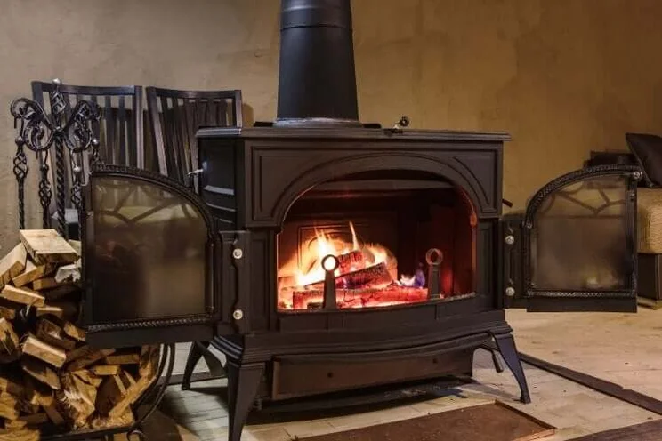 log burner in the middle of a room in a house