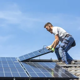 man installs a solar panel system