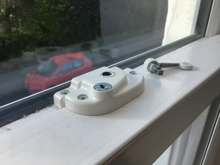 close up of broken lock on white uPVC window