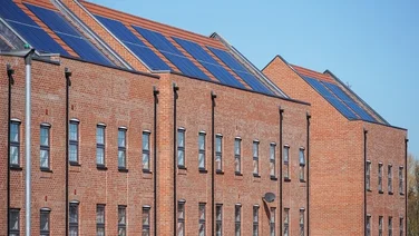 Solar panels on roof of apartment building in UK