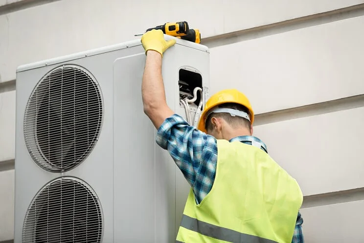 Specialist doing heat pump maintenance