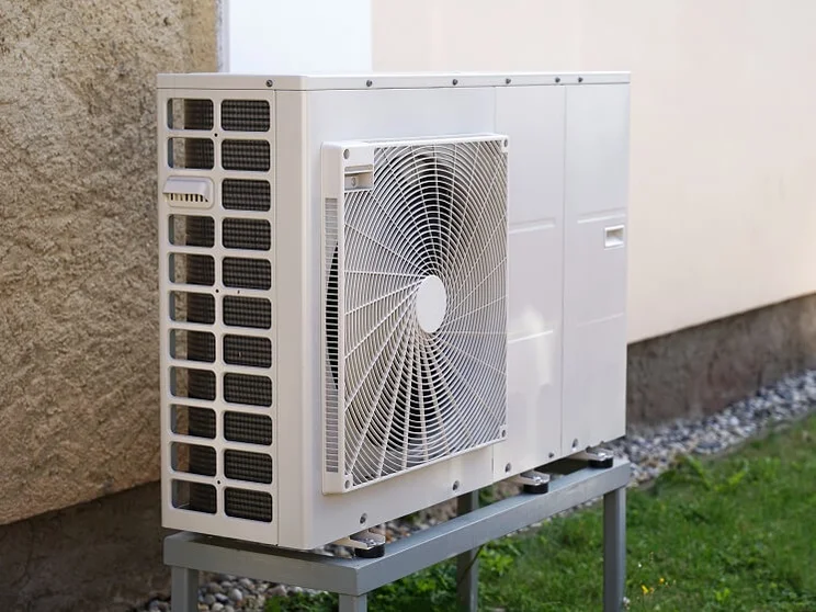 white air source heat pump unit outside house