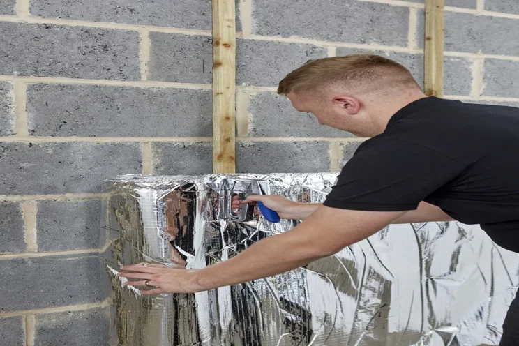Foil insulation being installed.