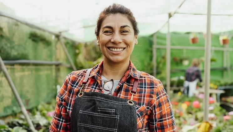 Smiling female flower shop employee