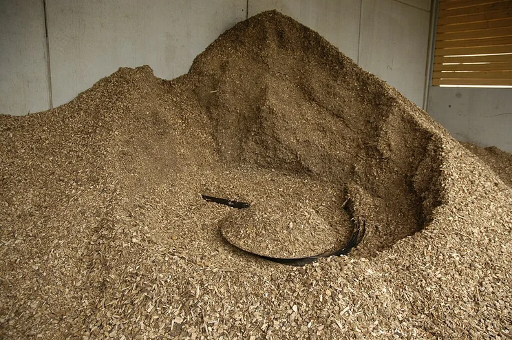 Biomass wood chips in a storage hopper.