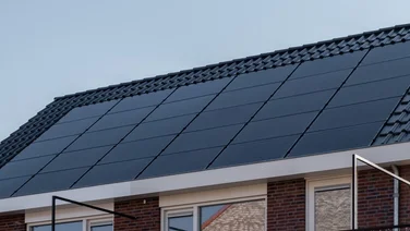 solar panels on a roof with a blue sky