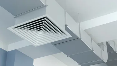 close up of white ventilation pipes inside a building