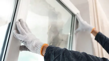 Someone installing a window