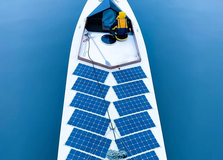 Top-down view of a boat with 12 solar panels on it