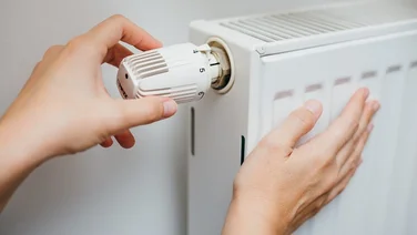 someone touching a radiator