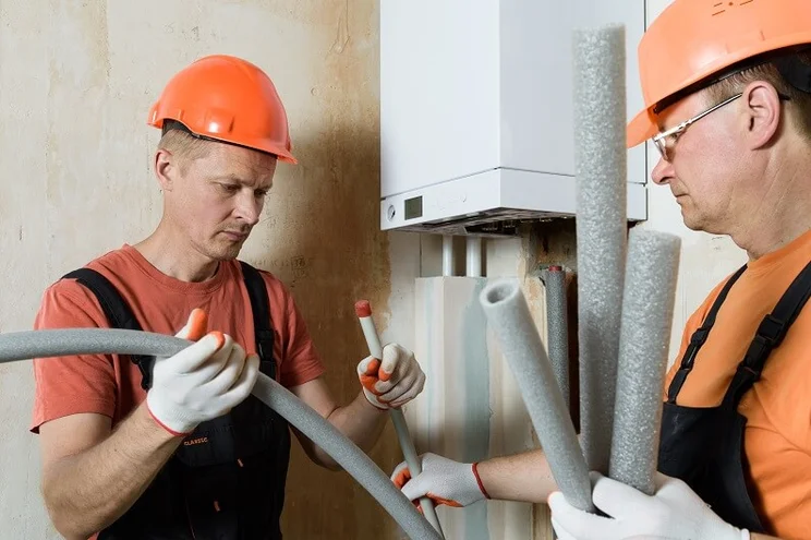Insulating pipes coming out of a boiler