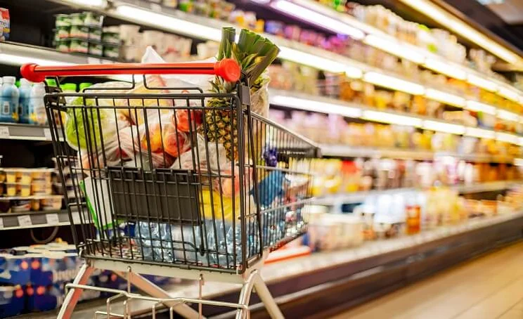 Trolley in a super market full of food