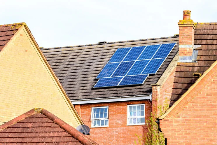 red brick house with solar panels on roof