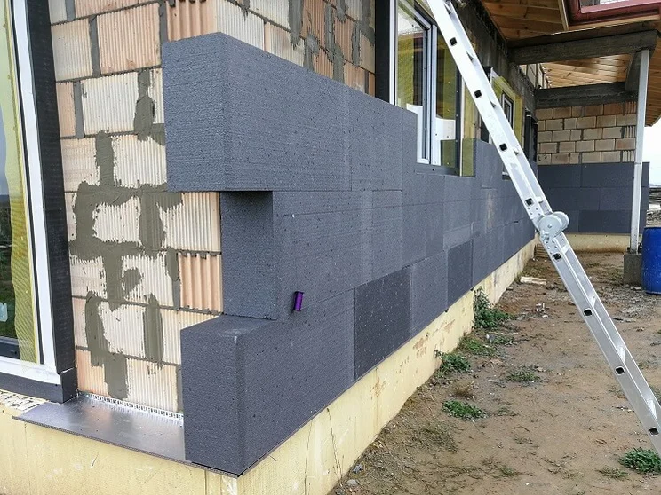 house with partially installed external wall insulation