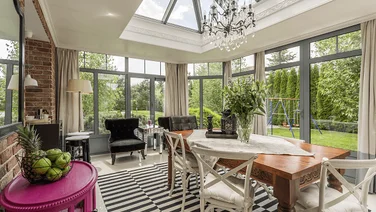 Conservatory with full-height glass windows and skylight