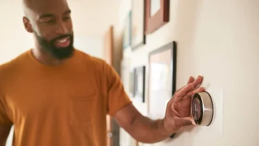 Person changing temperature at home