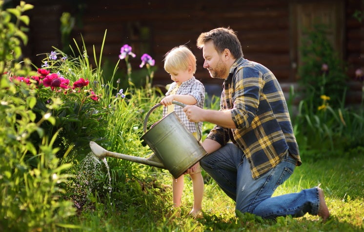 father and son water their garden