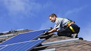 specialist installing solar panels