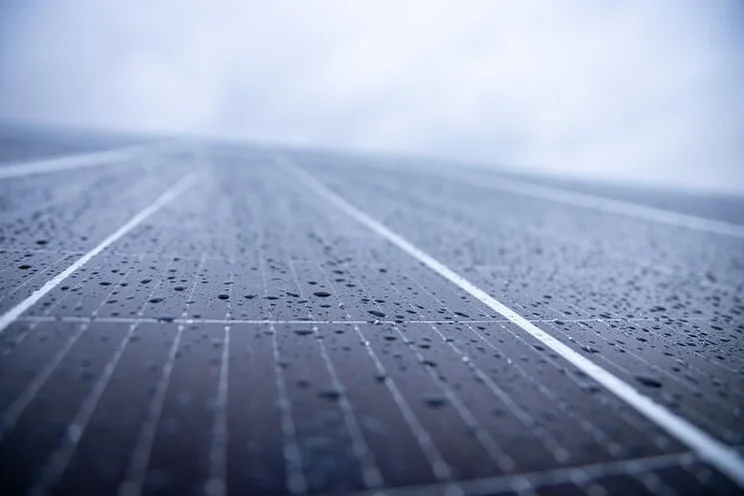 close up of solar panels with rain droplets on them