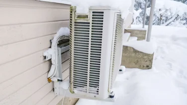 heat pump on wall in the snow