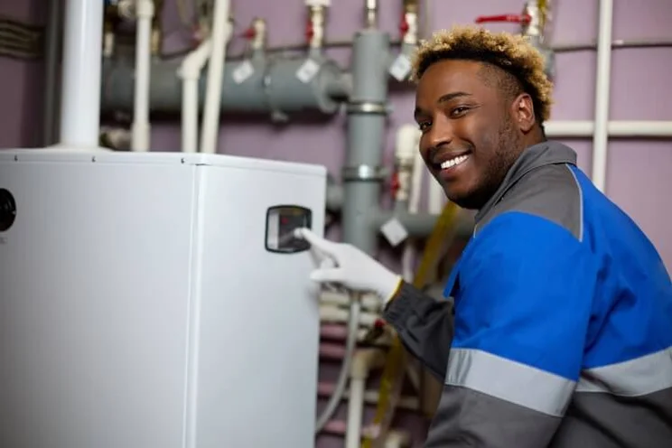 man fitting a boiler