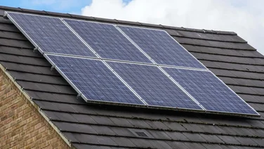 House with solar panels on the roof, against the sky