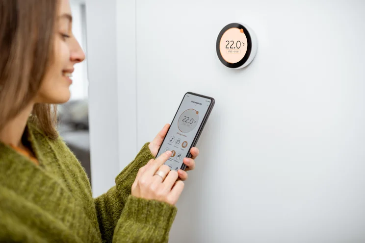 Person altering a smart thermostat