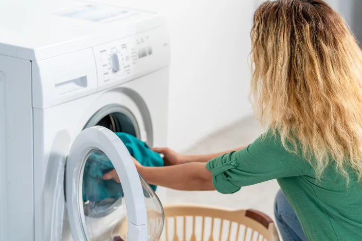 A person unloading a washing machine
