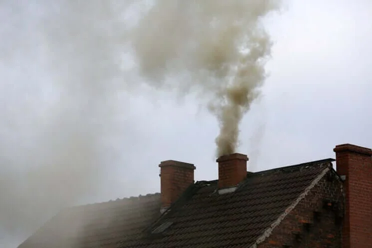 home chimney emitting dark smoke