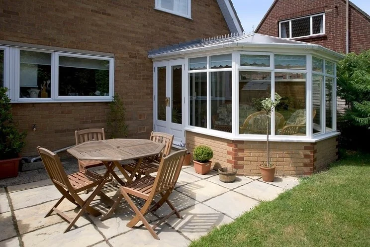 Garden with a glass conservatory in the UK