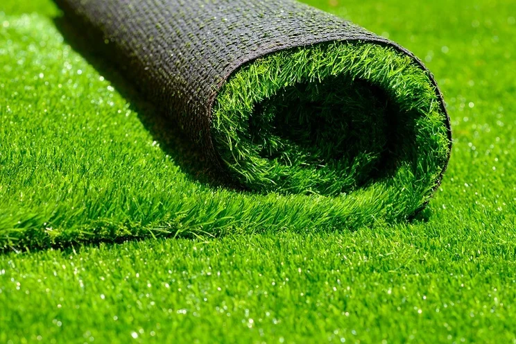 A close up of a roll of artificial grass