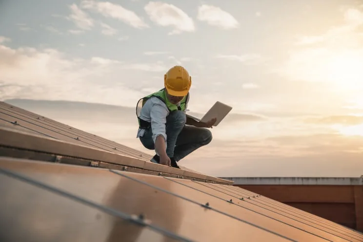 solar panel engineer checking on an installation