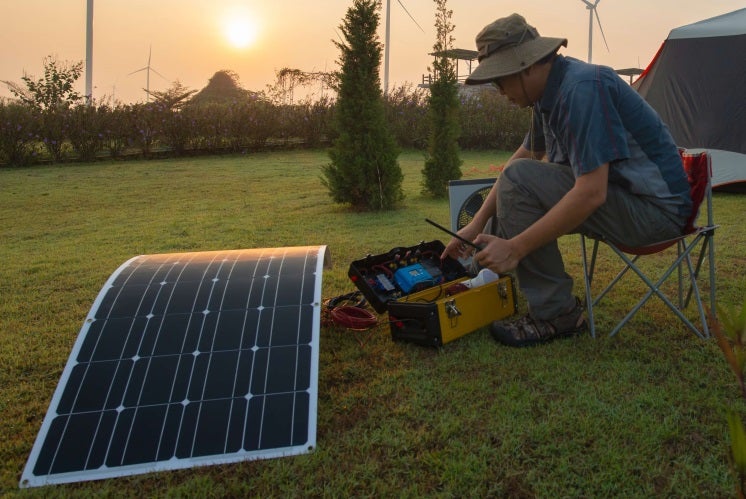man tests his flexible solar panel