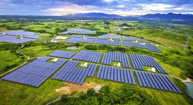 areal view of a solar farm in a green field